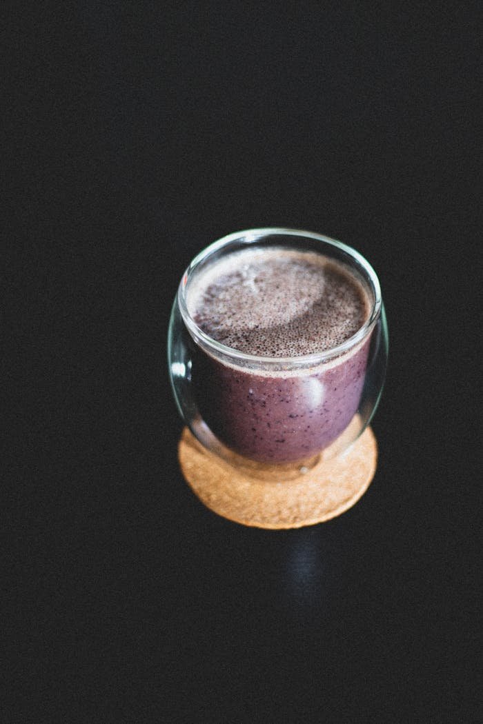 about-04 Refreshing berry smoothie served in transparent glass, showcasing healthy and delicious drink.