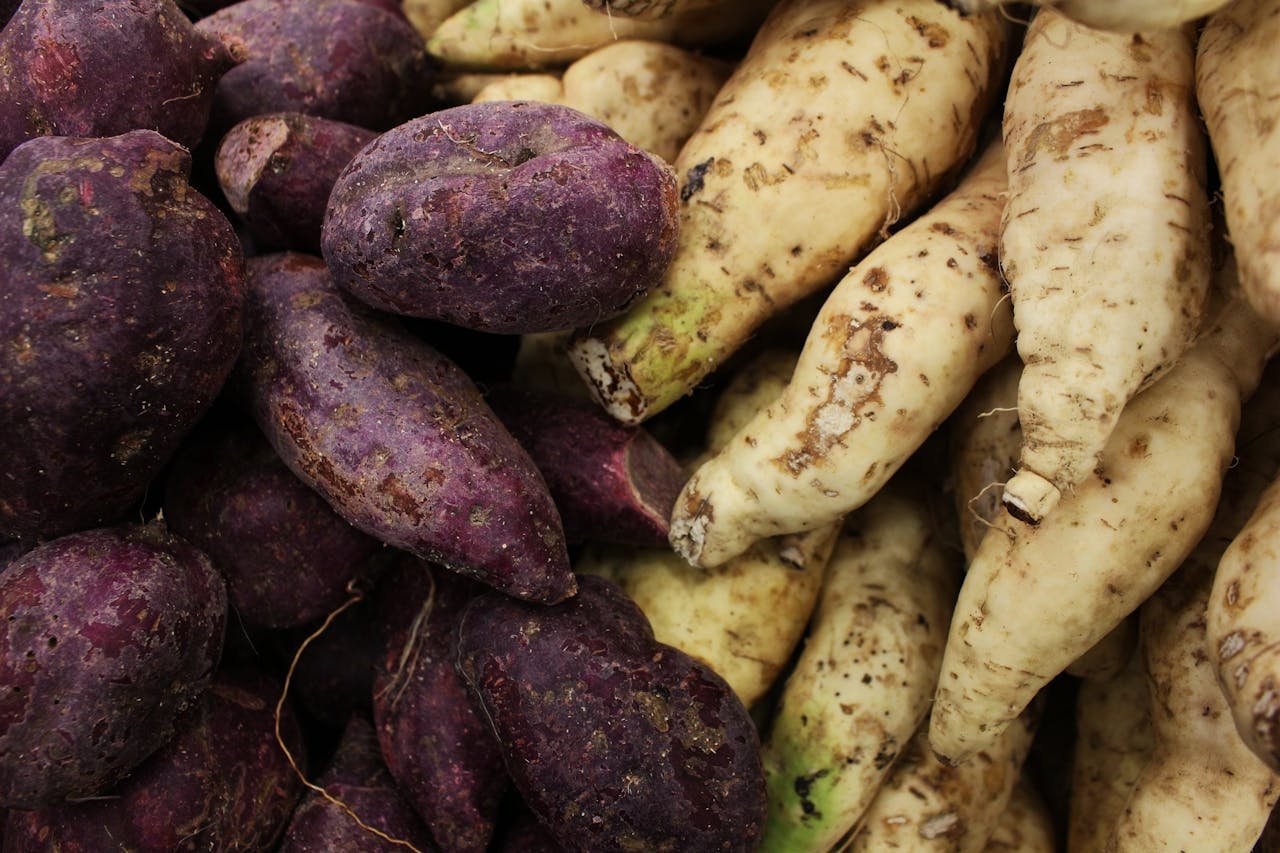 Crafting Captivating Headlines: Your awesome post title goes here A vibrant display of purple and white sweet potatoes and radishes piled together.